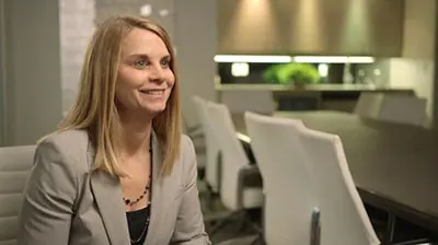 A business woman in a suit is being interviewed