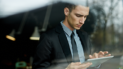 A young man in a suit on a tablet