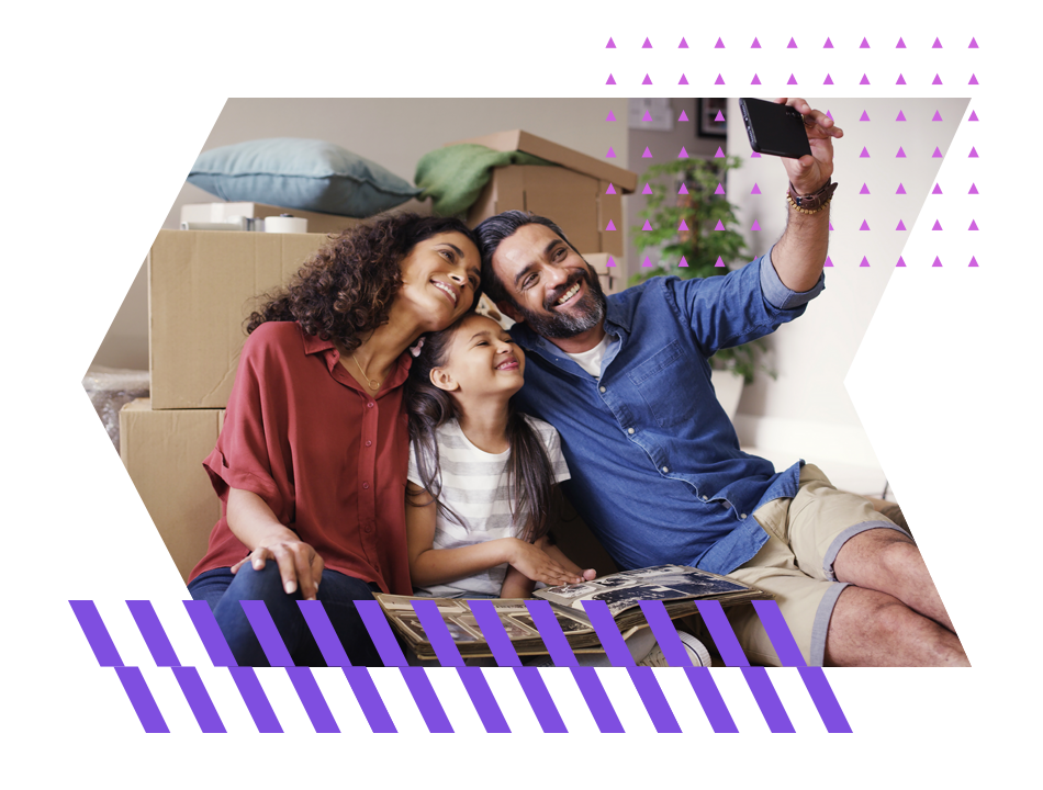 Family takes selfie in front of moving boxes